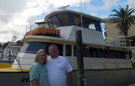 Wayne Martin standing in front of a boat